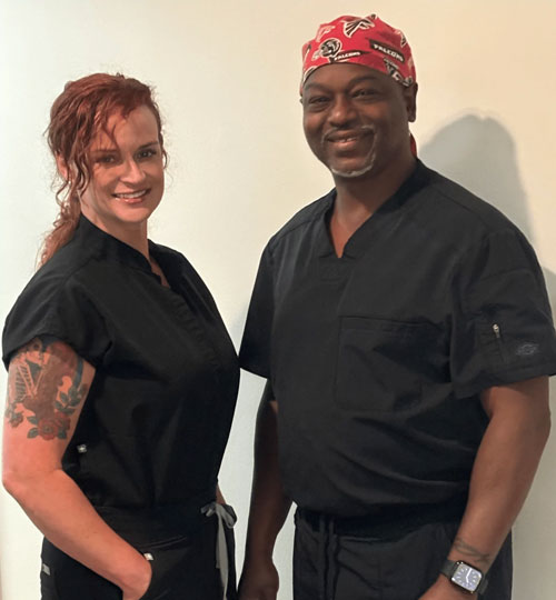 Two medical professionals in black scrubs